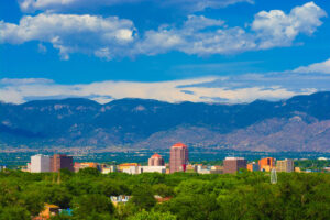 Albuquerque, New Mexico skyline and mountains behind city