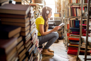 Girl listening to music in library