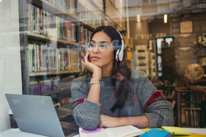 Musical studies student listening to music in bookstore