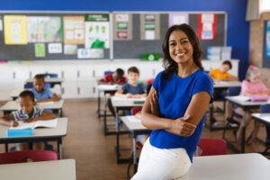 Teacher sitting on desk