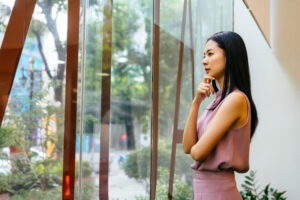 Woman thinking and gazing out office window