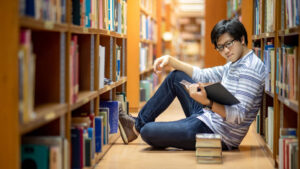 young man reading library
