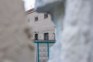 Old brick building surrounded by barbed wire