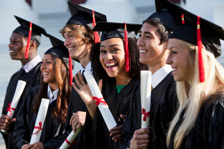 Optimistic graduates with diplomas on graduation day