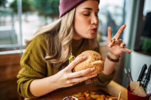 Woman eating messy burger