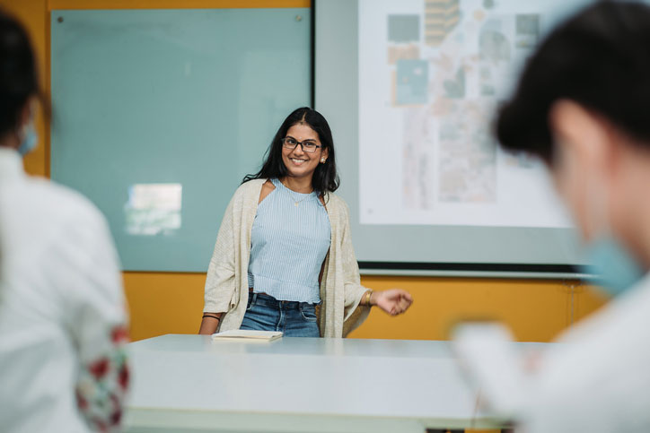 Young Asian professor in front of liberal arts class