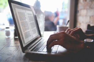 Editor working remotely in a cafe on a laptop