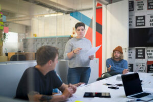 Newspaper editor talking with colleagues in office