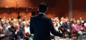 Male speaker at business event