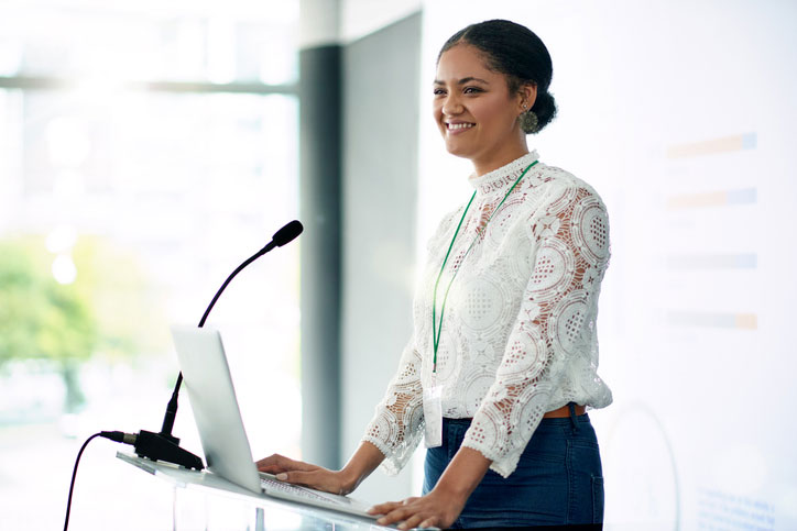Young female speaker at podium