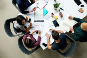 Table full of market research analysts working on project