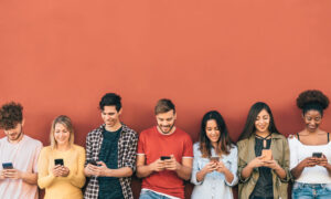 Young group of adults using smartphones