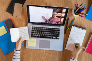 Student learning online from teacher on laptop