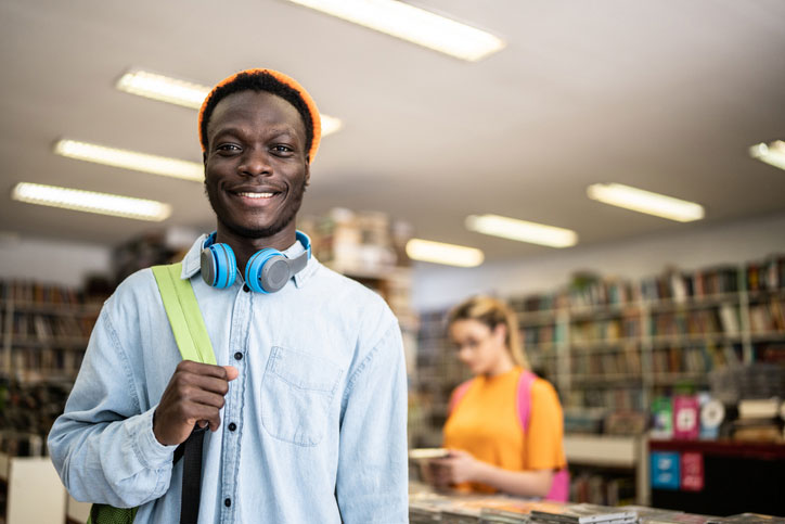 young student smiling in bookstore